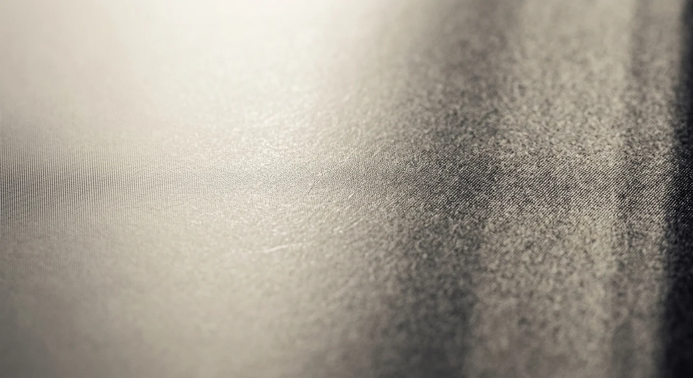 Close-up macro texture showing a gradient transition from smooth fine mesh to grainy, rough fabric surface.